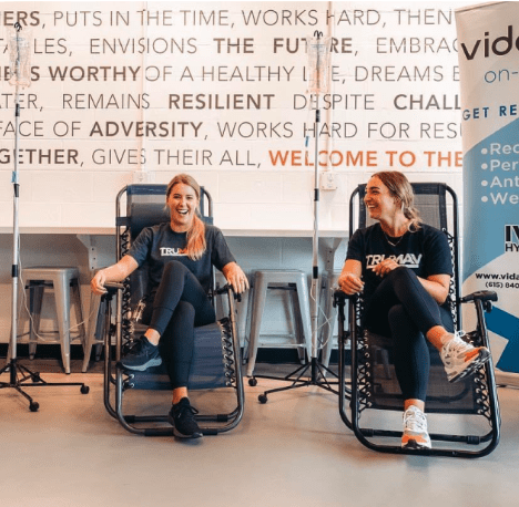 An image of two people receiving a group IV treatment from Vida-Flo.